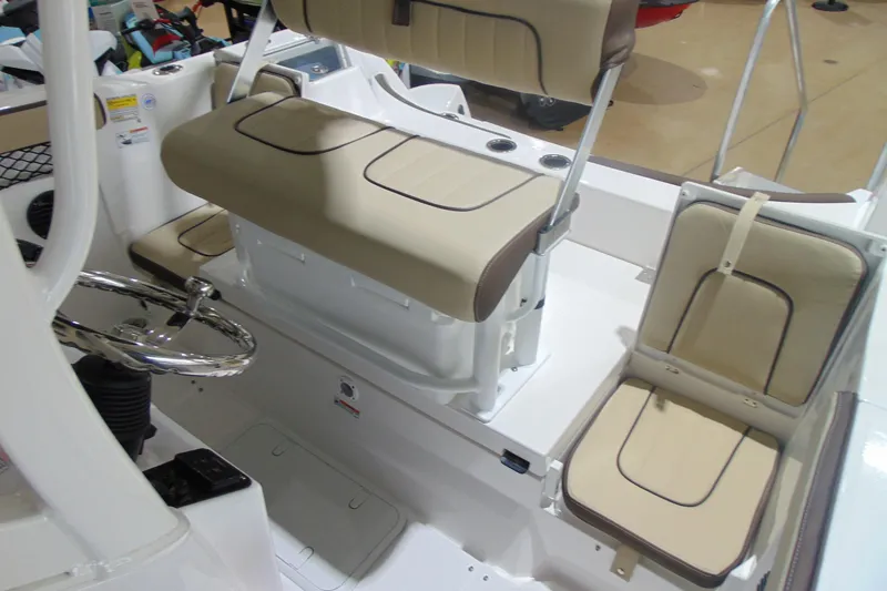 Slide: The Image of 2026 Yamaha Boats 222 FSH Sport E interior with beige seating and steering wheel. - 15