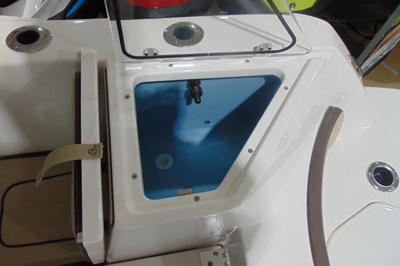 Slide: The Image of 2026 Yamaha Boats 222 FSH Sport E livewell compartment, open and empty. - 16