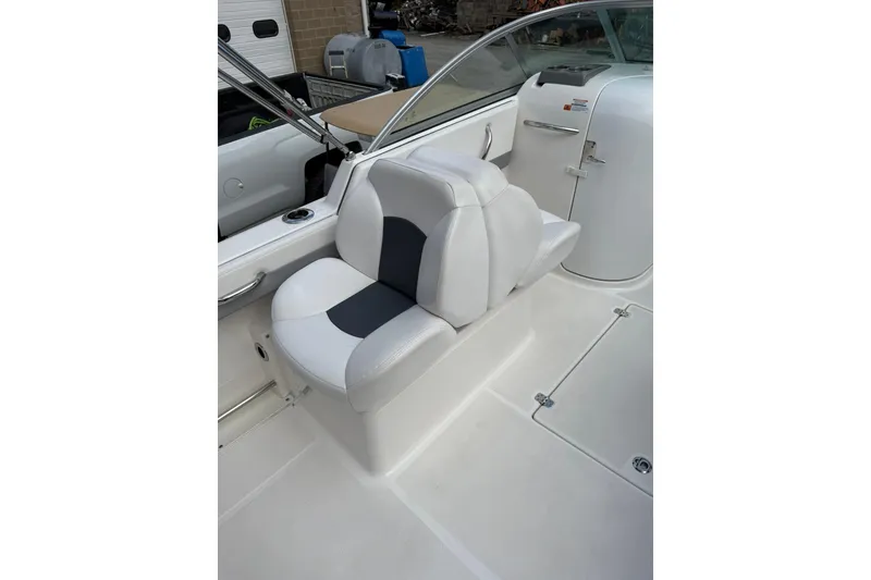 Slide: The Image of 2021 Robalo R227 Dual Console boat interior with white and gray seating. - 10