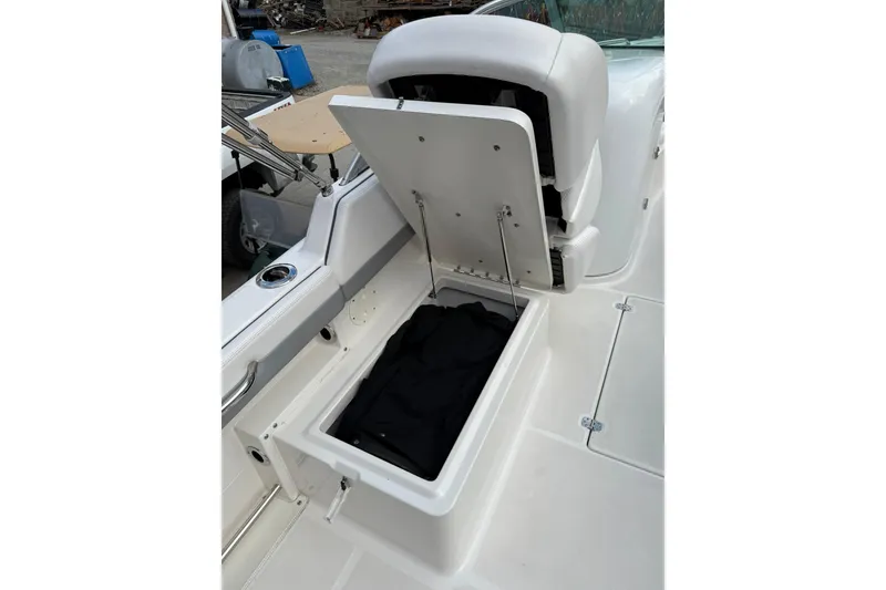 Slide: The Image of 2021 Robalo R227 Dual Console boat with open storage compartment. - 11