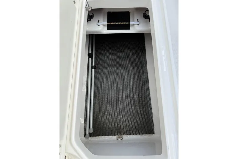 Slide: The Image of Storage compartment of 2021 Robalo R227 Dual Console boat, featuring a clean, organized interior. - 13