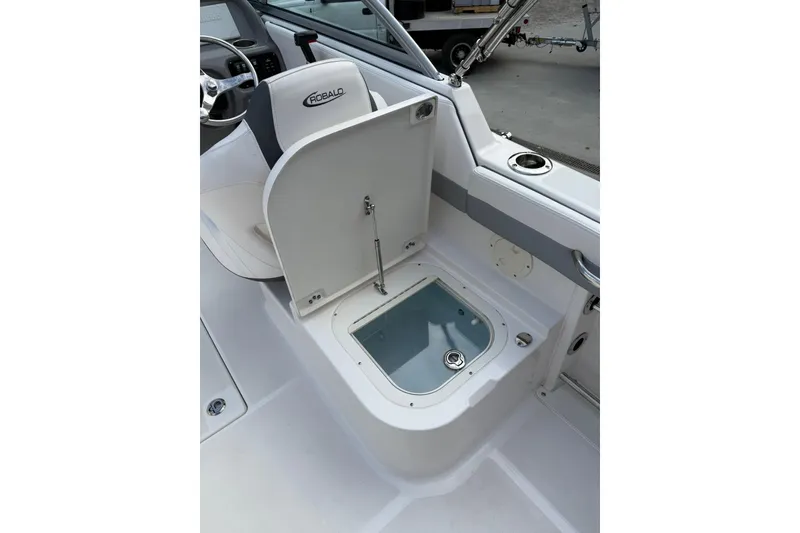 Slide: The Image of 2021 Robalo R227 Dual Console boat interior with open storage compartment. - 14