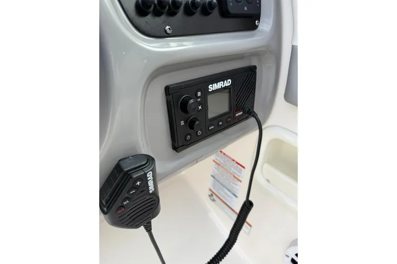 Slide: The Image of Simrad marine radio on 2021 Robalo R227 Dual Console dashboard. - 17