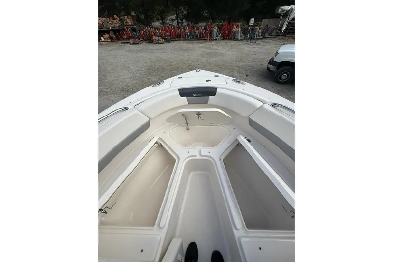 Slide: The Image of 2021 Robalo R227 Dual Console boat interior with open storage compartments. - 22