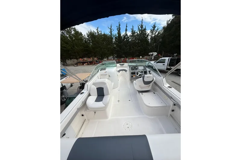 Slide: The Image of 2021 Robalo R227 Dual Console boat interior with seating and steering wheel. - 6