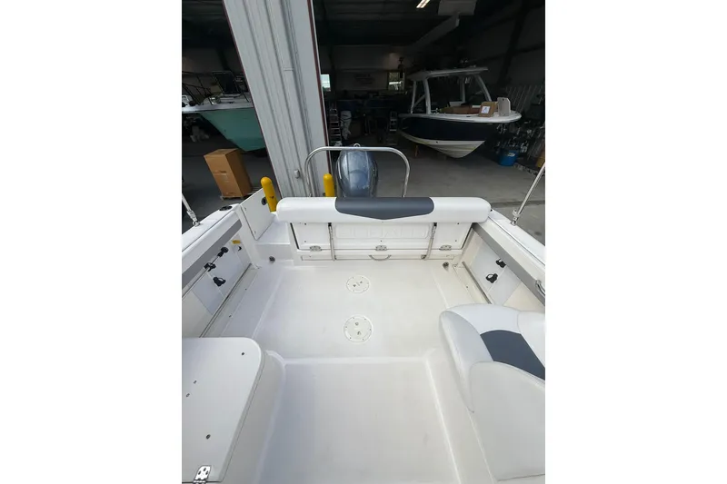 Slide: The Image of 2021 Robalo R227 Dual Console boat interior in a storage facility. - 7