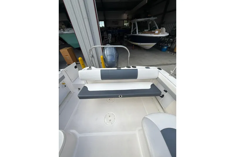 Slide: The Image of 2021 Robalo R227 Dual Console boat interior with seating and storage. - 8