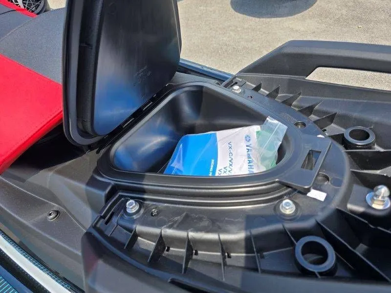 Slide: The Image of Yamaha Waverunner VX Deluxe 2026 storage compartment with audio accessories. - 18