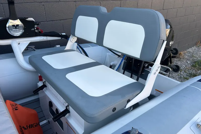Slide: The Image of 2024 Highfield Classic 310 FCT boat interior with dual seating and Tohatsu engine. - 3