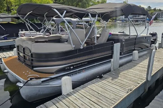 The Image of 2013 Premier 275 Boundary Waters pontoon boat docked on a sunny day. - 0