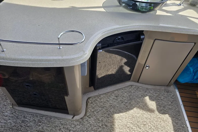 Slide: The Image of 2013 Premier 275 Boundary Waters boat interior with countertop and storage cabinets. - 10