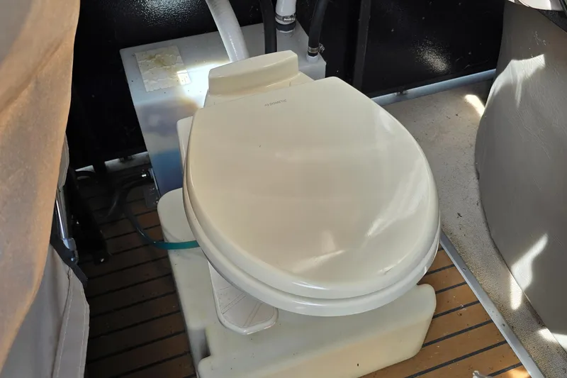 Slide: The Image of Boat toilet in 2013 Premier 275 Boundary Waters, featuring a compact design and wooden flooring. - 12