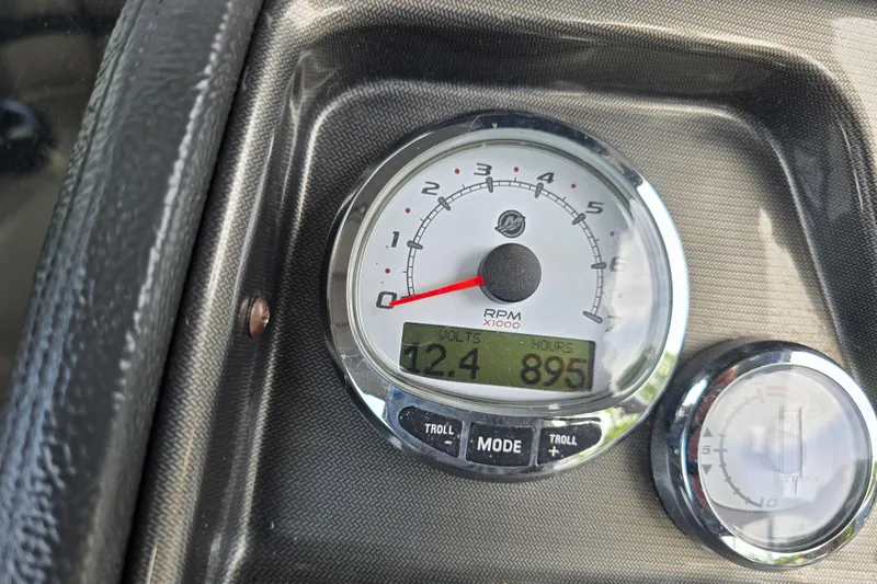 Slide: The Image of Dashboard of 2013 Premier 275 Boundary Waters showing RPM gauge and digital display. - 4