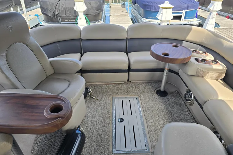 Slide: The Image of Interior of a 2013 Premier 275 Boundary Waters pontoon boat with plush seating and tables. - 5
