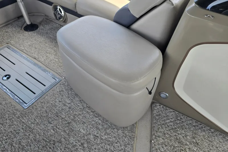 Slide: The Image of 2013 Premier 275 Boundary Waters boat interior with cushioned seating and carpeted flooring. - 7