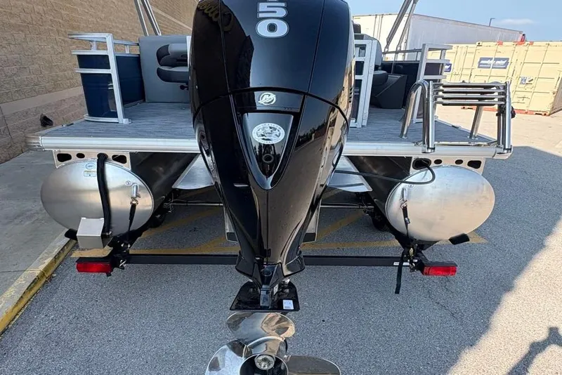 Slide: The Image of 2026 Sun Tracker SportFish 22 DLX pontoon boat with a 50 HP outboard motor. - 2