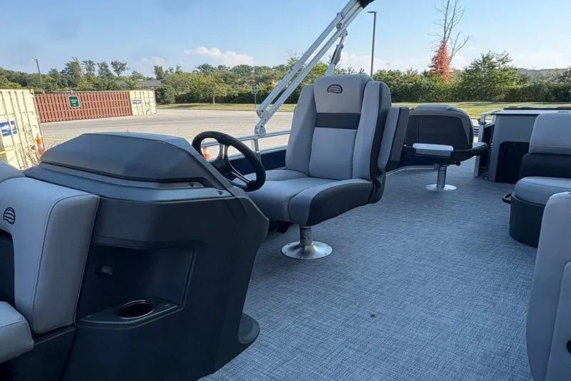 Slide: The Image of 2026 Sun Tracker SportFish 22 DLX pontoon boat interior with modern seating and steering console. - 4