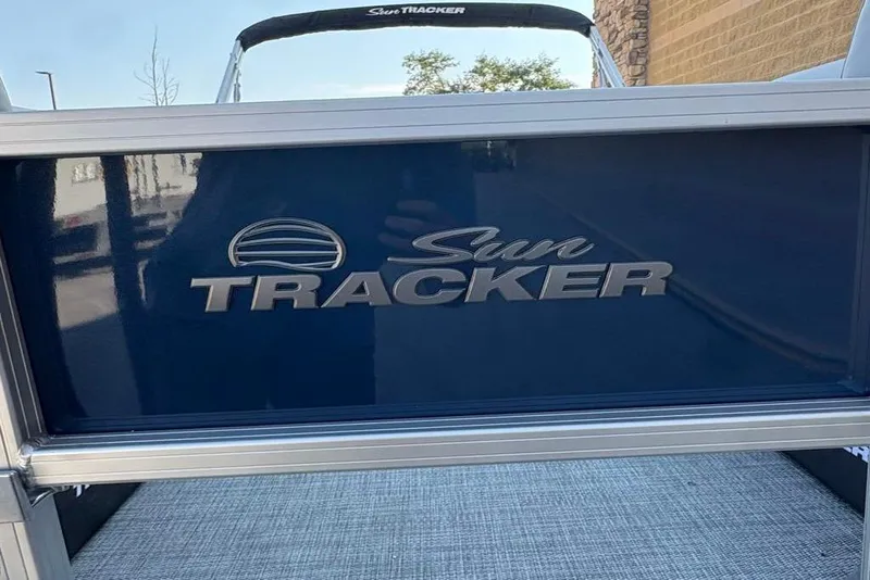 Slide: The Image of 2026 Sun Tracker SportFish 22 DLX boat with logo detail. - 8