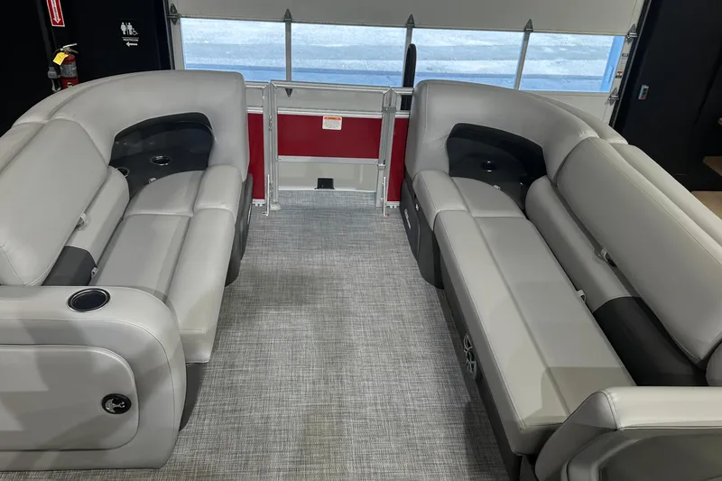 Slide: The Image of 2026 Sun Tracker SportFish 22 DLX interior with gray seating and cup holders. - 12
