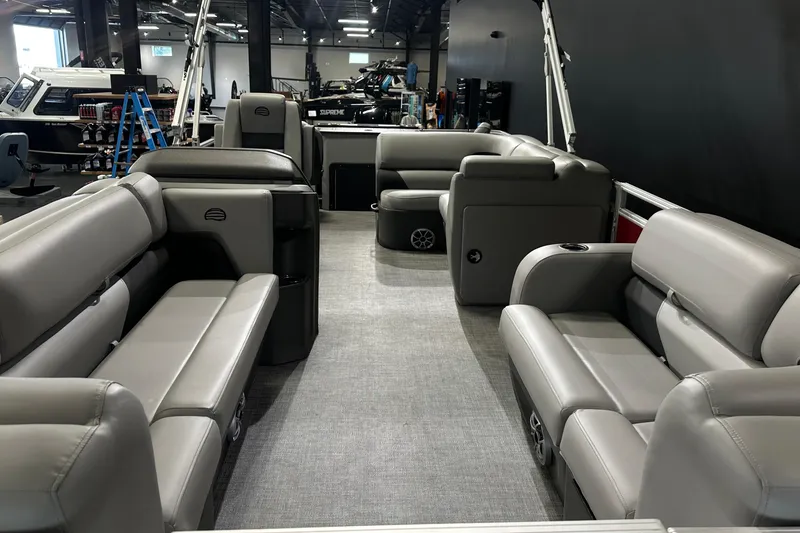 Slide: The Image of 2026 Sun Tracker SportFish 22 DLX pontoon boat interior with gray seating and spacious layout. - 19