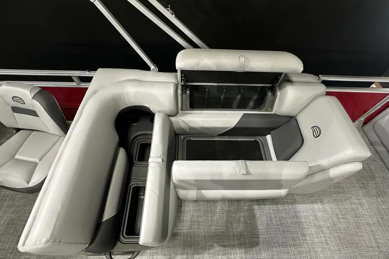 Slide: The Image of 2026 Sun Tracker SportFish 22 DLX boat interior with gray seating and storage compartments. - 23
