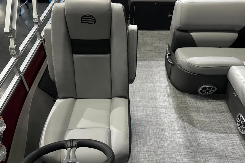 Slide: The Image of 2026 Sun Tracker SportFish 22 DLX interior with gray seating and steering wheel. - 27