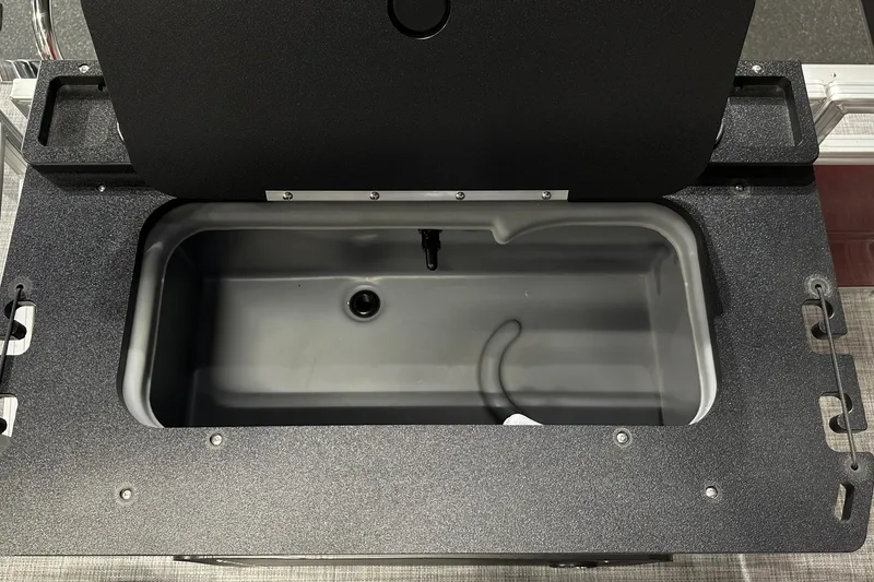 Slide: The Image of Open storage compartment on 2026 Sun Tracker SportFish 22 DLX boat. - 35
