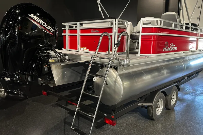 Slide: The Image of 2026 Sun Tracker SportFish 22 DLX pontoon boat with Mercury engine on trailer. - 7
