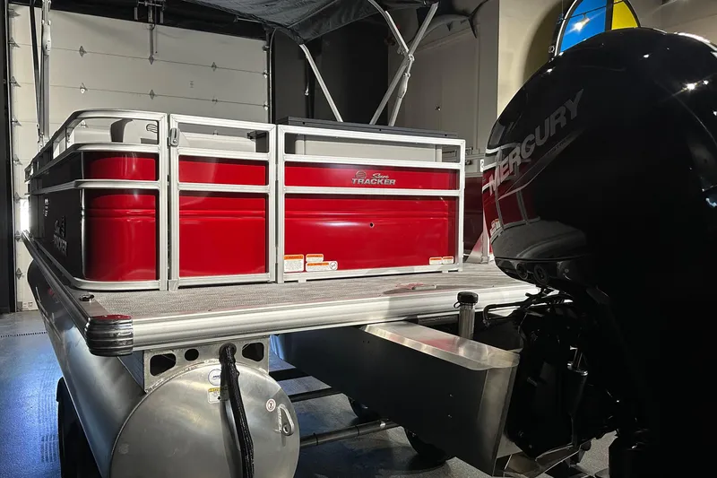 Slide: The Image of 2026 Sun Tracker SportFish 22 DLX pontoon boat with Mercury engine in a garage. - 8