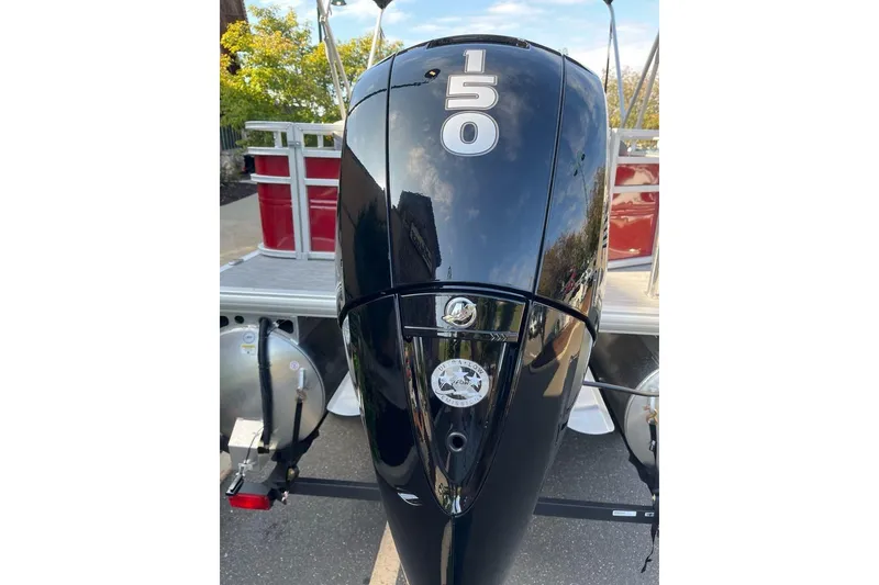 Slide: The Image of 2026 Sun Tracker SportFish 22 DLX with powerful 150 HP outboard motor. - 2