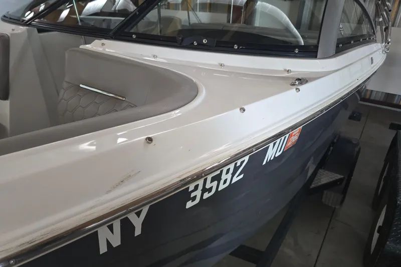 Slide: The Image of 2023 Four Winns H1 boat interior with gray seating and cup holders. - 10