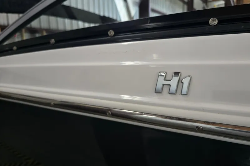 Slide: The Image of 2023 Four Winns H1 boat interior with gray seating and cup holders. - 11