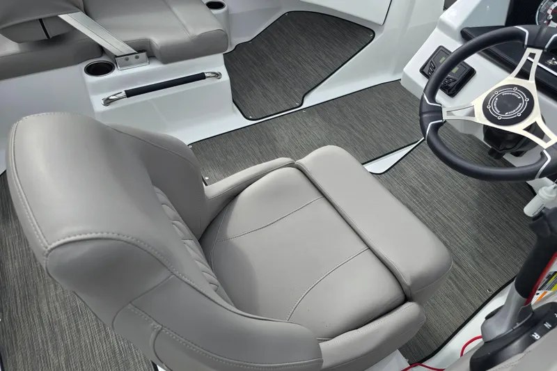 Slide: The Image of 2023 Four Winns H1 boat dashboard with steering wheel and gauges. - 15