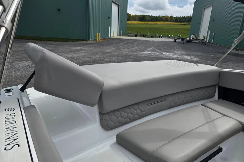 Slide: The Image of 2023 Four Winns H1 boat interior with seating and dashboard, showcasing modern design. - 17
