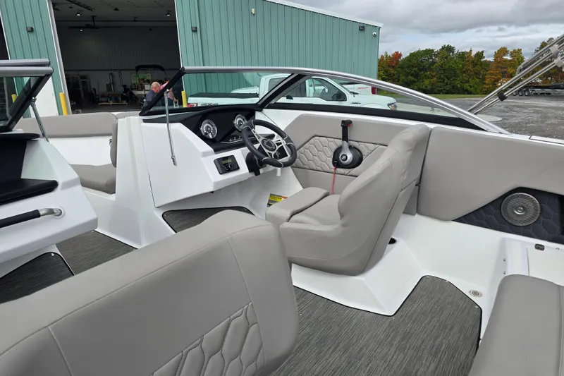 Slide: The Image of 2023 Four Winns H1 boat interior with modern dashboard and comfortable seating. - 19