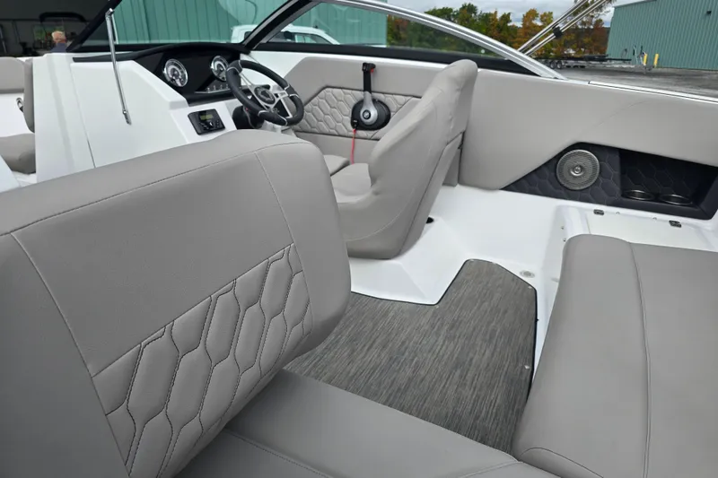 Slide: The Image of 2023 Four Winns H1 boat interior with gray cushioned seating and hexagonal pattern design. - 20