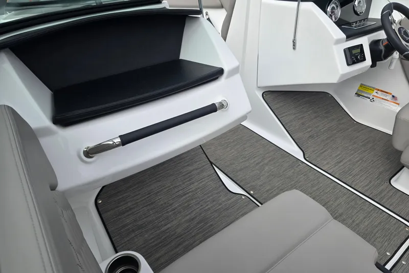 Slide: The Image of 2023 Four Winns H1 boat interior with gray seating and modern dashboard. - 24