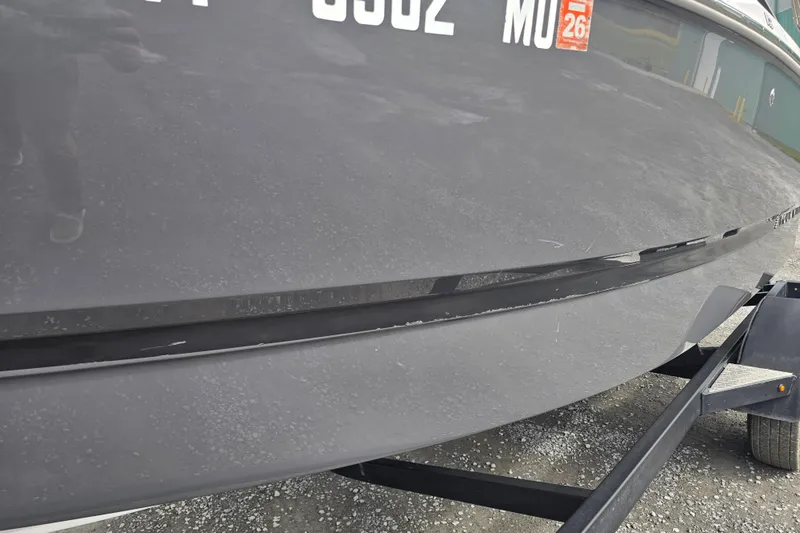 Slide: The Image of 2023 Four Winns H1 boat interior with gray seating and modern dashboard. - 26