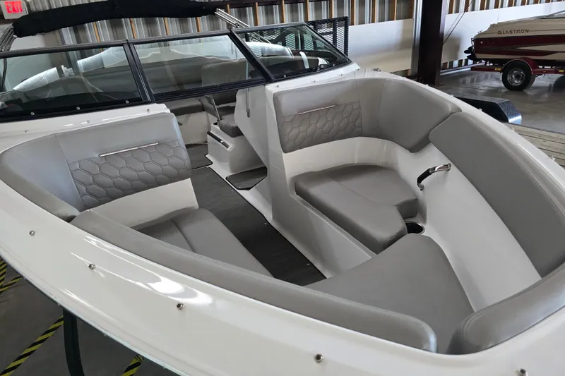 Slide: The Image of 2023 Four Winns H1 boat detail with metal trim and screws under a cloudy sky. - 3