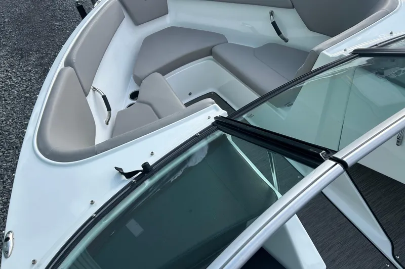 Slide: The Image of 2023 Four Winns H1 boat interior with sleek seating and windshield design. - 33