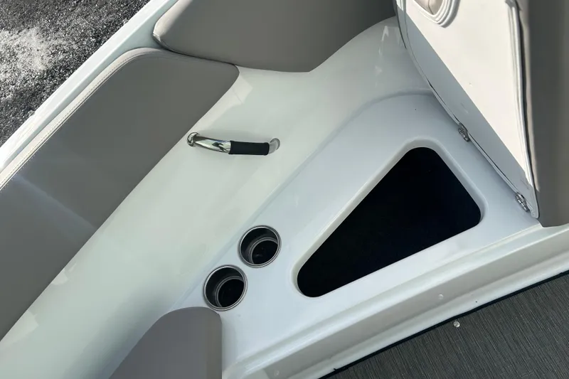 Slide: The Image of 2023 Four Winns H1 boat interior with cup holders and storage compartment. - 36