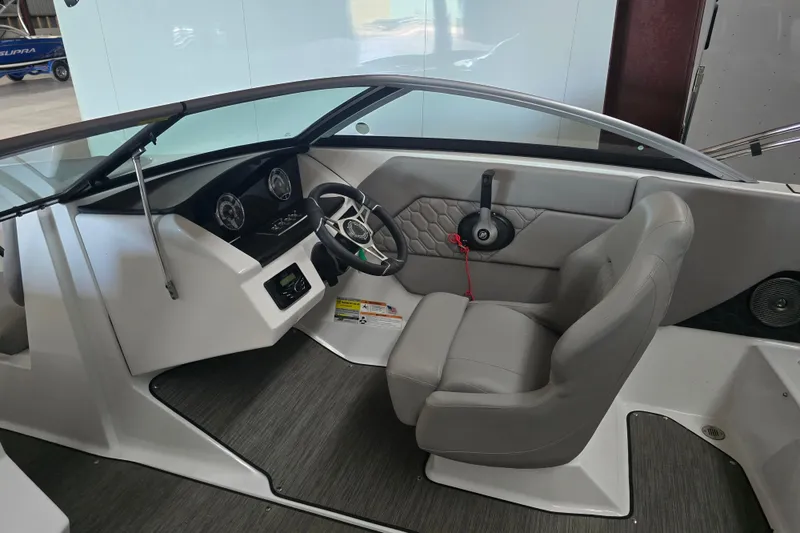 Slide: The Image of 2023 Four Winns H1 boat on trailer outside a large green building. - 5