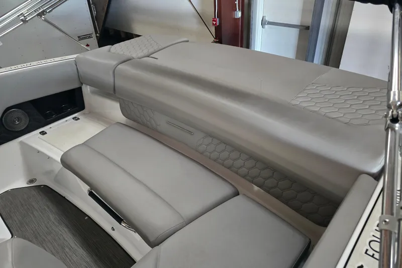 Slide: The Image of 2023 Four Winns H1 boat, close-up of sleek hull design and branding. - 7