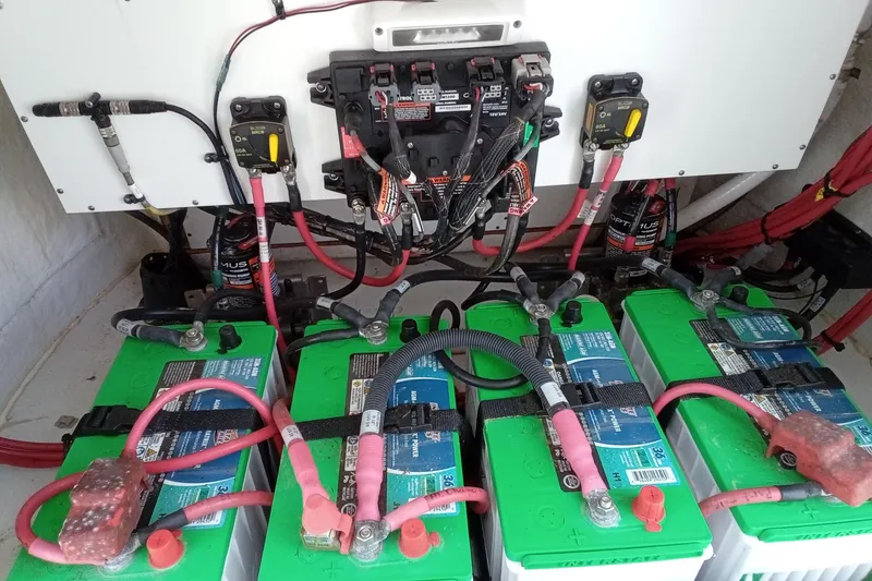 Slide: The Image of 2022 Sportsman Open 302 Center Console battery compartment with wiring and connections. - 15