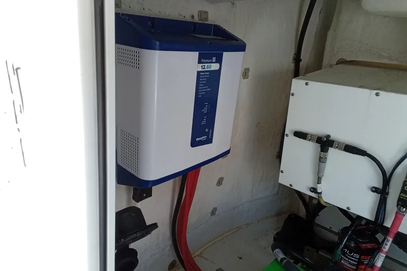 Slide: The Image of 2022 Sportsman Open 302 Center Console electrical components in boat interior. - 16