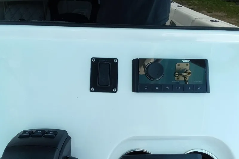 Slide: The Image of 2022 Sportsman Open 302 Center Console dashboard with Fusion audio system and controls. - 17