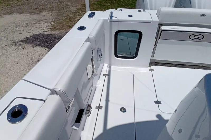 Slide: The Image of 2022 Sportsman Open 302 Center Console boat interior with white seating and deck. - 19