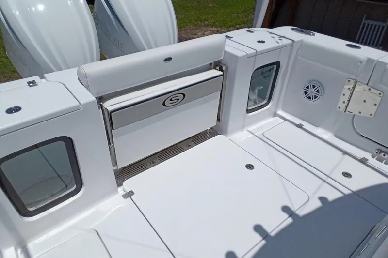 Slide: The Image of 2022 Sportsman Open 302 Center Console boat interior with storage and seating features. - 20