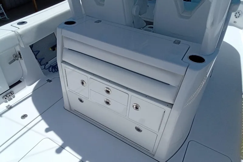 Slide: The Image of 2022 Sportsman Open 302 Center Console boat interior with storage compartments. - 22