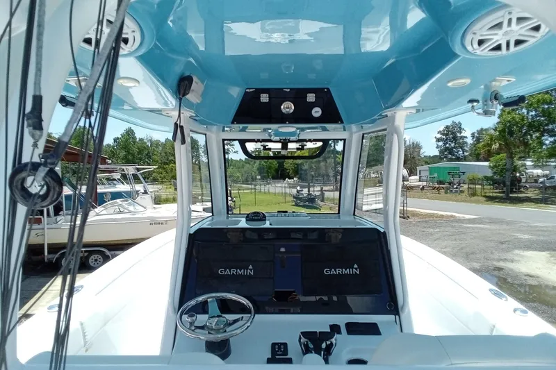 Slide: The Image of 2022 Sportsman Open 302 Center Console boat interior with Garmin navigation system. - 24